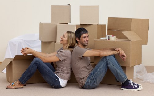 Moving boxes and furniture in a Bowespark apartment corridor